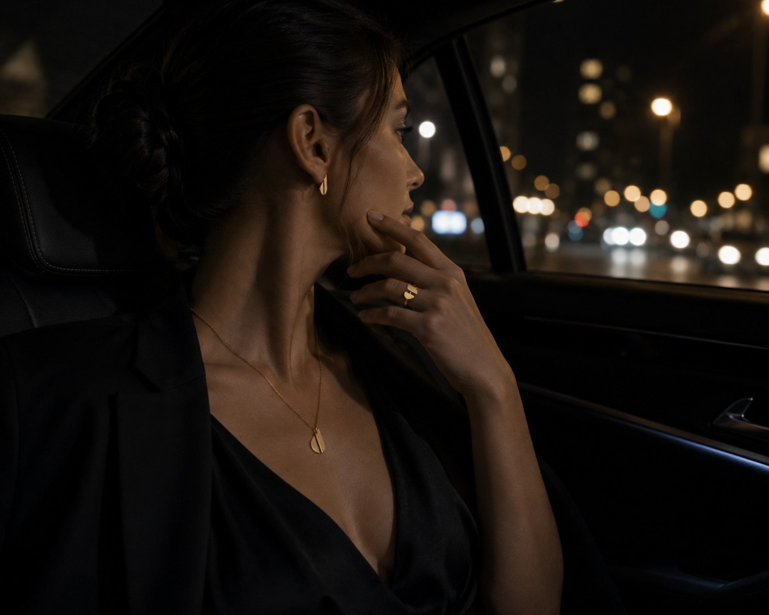 Woman wearing JUNO signature jewellery in an evening setting