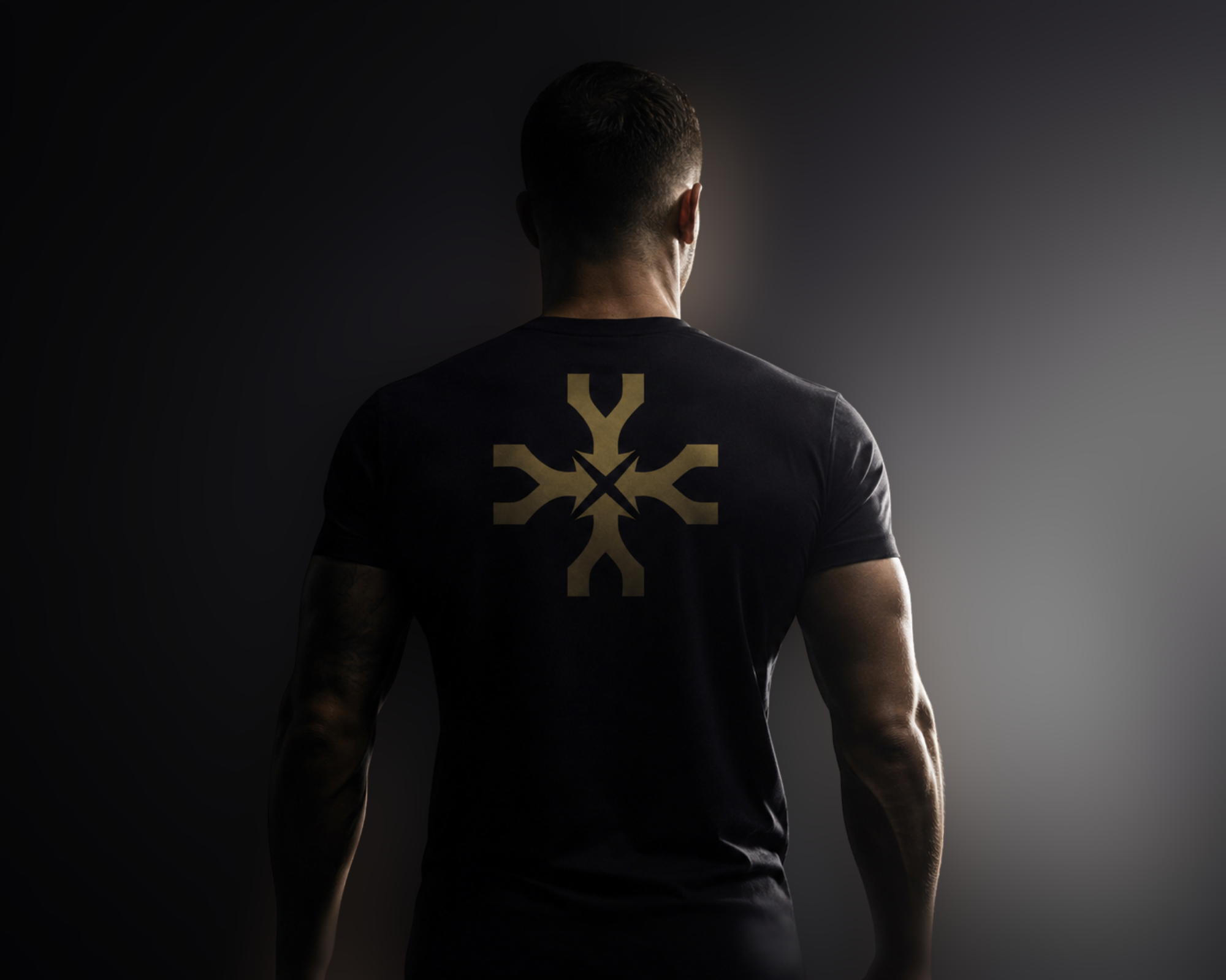 UNDER IV emblem applied to the back of a black training shirt